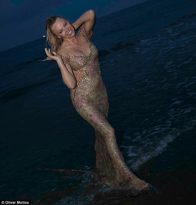 Pamela Anderson kicks off her heels for a dip in the ocean while wearing fancy gown at club opening