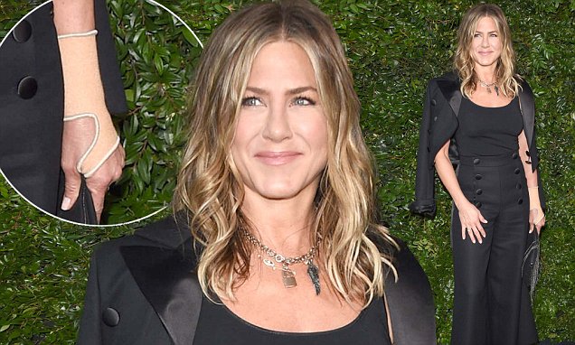 Jennifer Aniston continues to wear an arm brace but has yet to divulge the details of her