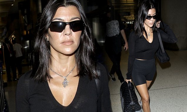 Kourtney Kardashian saunters through the airport wearing skintight bike shorts and sporty sunglasses