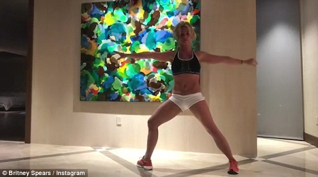 Britney Spears shows off her incredible flexibility as she performs yoga moves in a crop top and hotpants