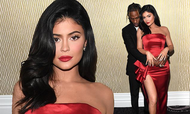 Kylie Jenner is a siren in scarlet as she and Travis Scott embrace backstage at Clive Davis bash