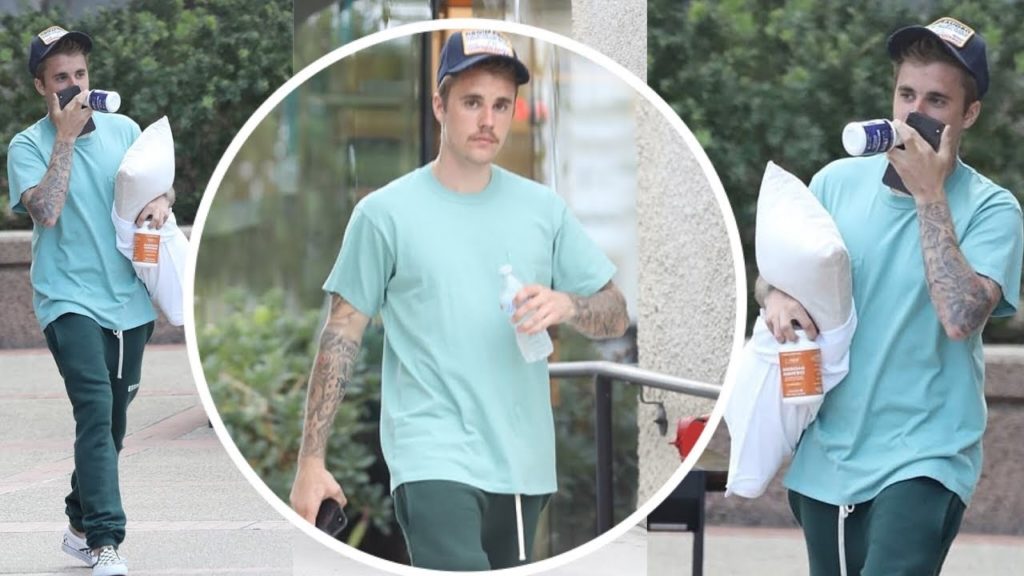 Justin Bieber carries a pillow and some vitamin supplements in LA