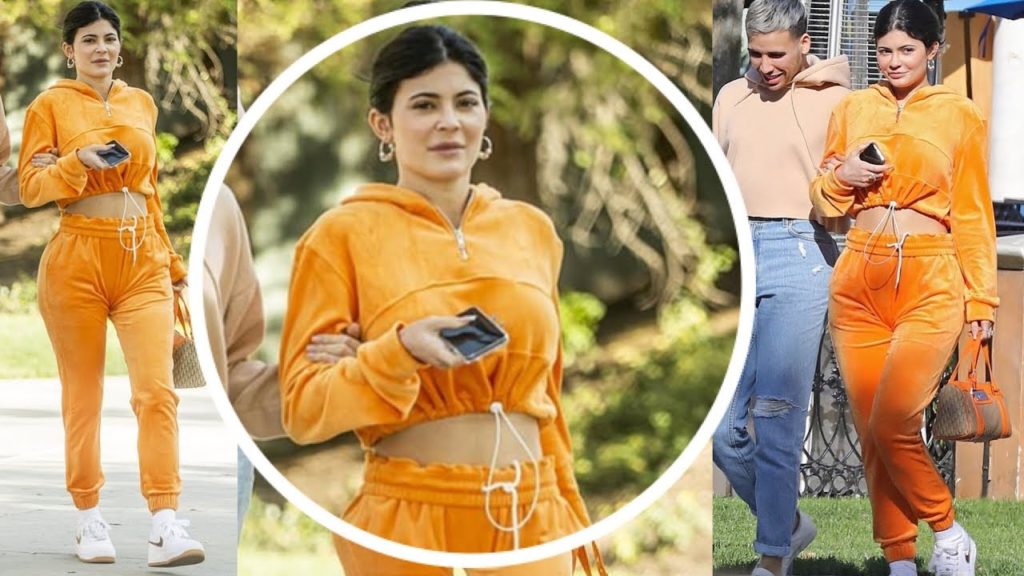 Kylie Jenner flashes her midriff in orange tracksuit as she goes makeup-free for lunch in LA