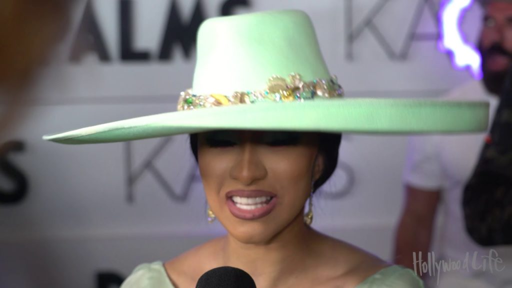 Cardi B reveals tongue piercing & caresses Dan Bilzerian’s face before KAOS Performance