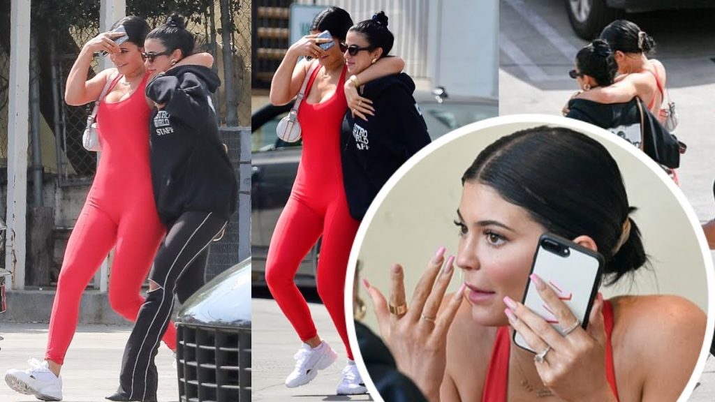 Kylie Jenner in red jumpsuit and swept her dark hair back into a bun step out in LA