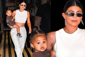 Kylie Jenner flaunts her toned tummy in a creamy crop top with Stormi on her hip